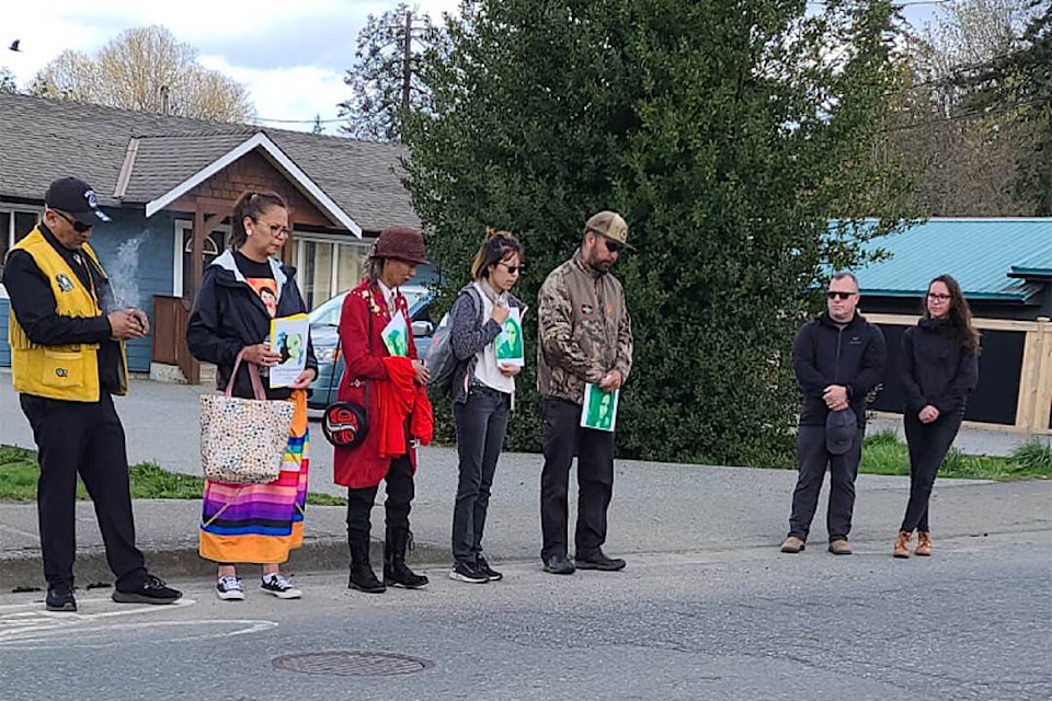 Nicola-Cree Belcourt’s family members hold posters of the young woman near the place in Port Alberni where her body was found on April 2, 2022. Her family is appealing to anyone with information on her death to please come forward. (SUBMITTED PHOTO)