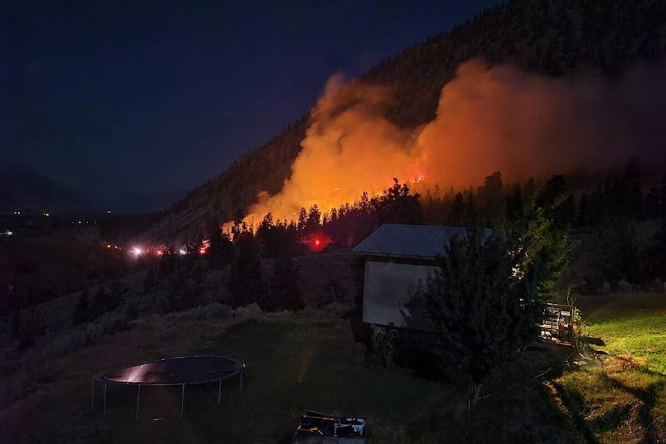 Flames from a vehicle fire on Highway 3 spread up hill. (Facebook)