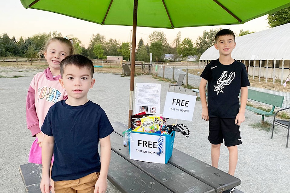 Audrey Warren, 7, and brothers Bennett, 4, and Nolan, 8, leave a box of free pet treats at the dog park behind Planet Ice in honour of their uncle Trent Edward Gibney for Suicide Prevention Month. (Special to The News)