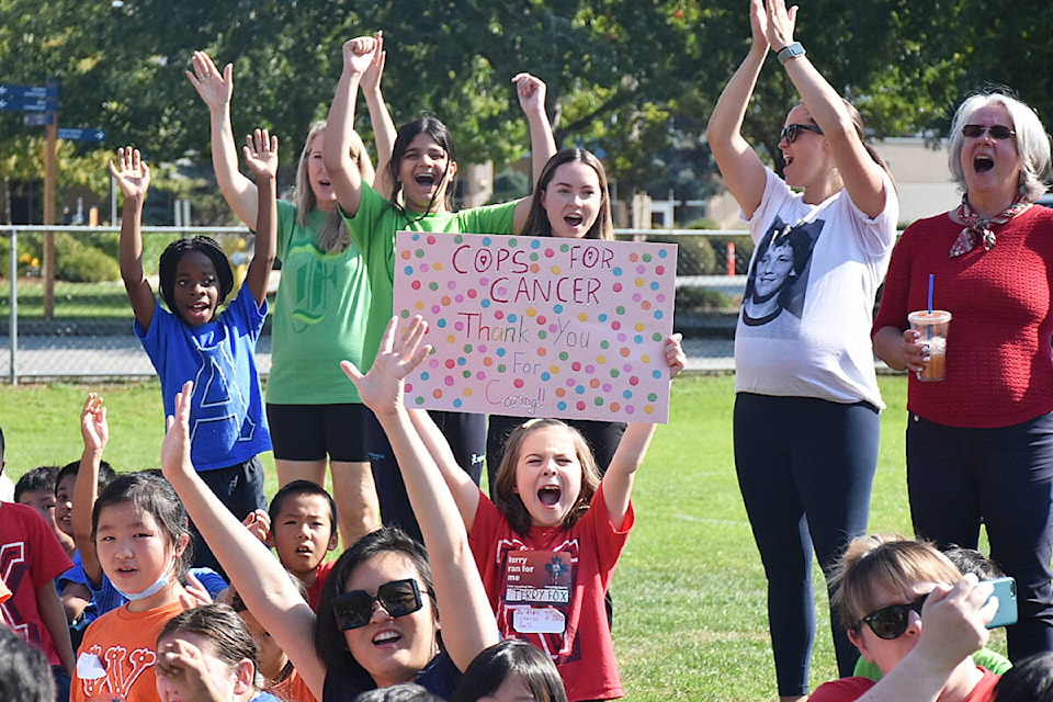 Students cheer as members of the Cops for Cancer Tour de Coast arrive at Meadowridge School on Tuesday, Sept. 27. (Colleen Flanagan/The News)