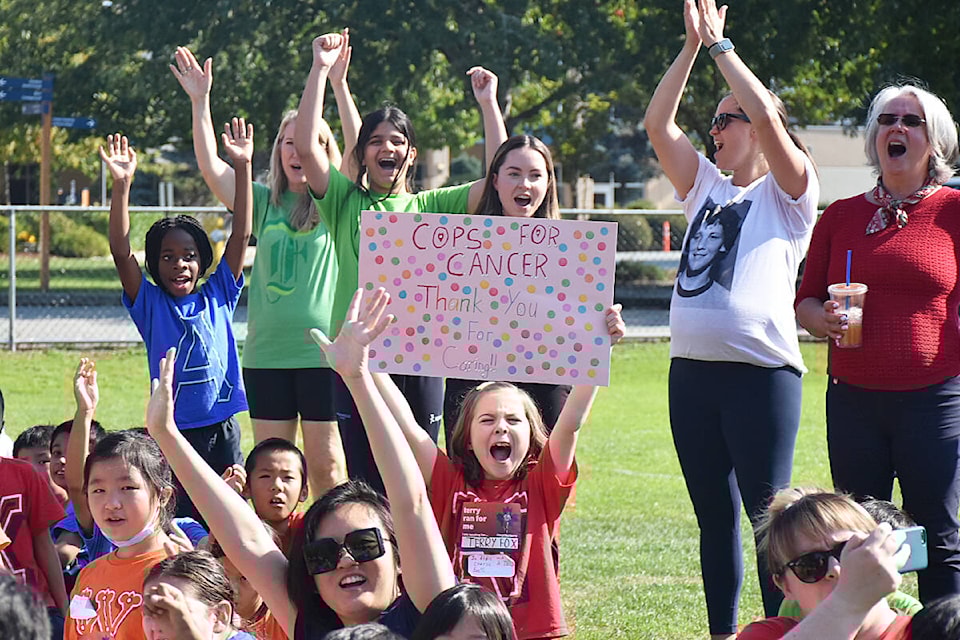 Students cheer as members of the Cops for Cancer Tour de Coast arrive at Meadowridge School on Tuesday, Sept. 27. (Colleen Flanagan/The News)