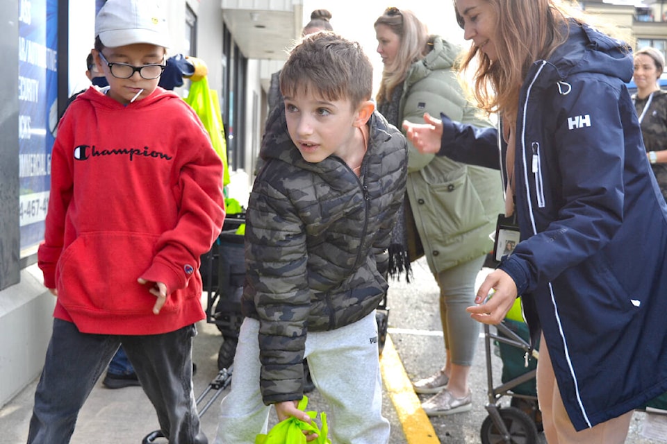 Students from Eric Langton Elementary School collect their bags of nutritious snacks from the Starfish Pack Program and bring them back to school, where they will be stored for students in need until the following Thursday. (Brandon Tucker/The News)