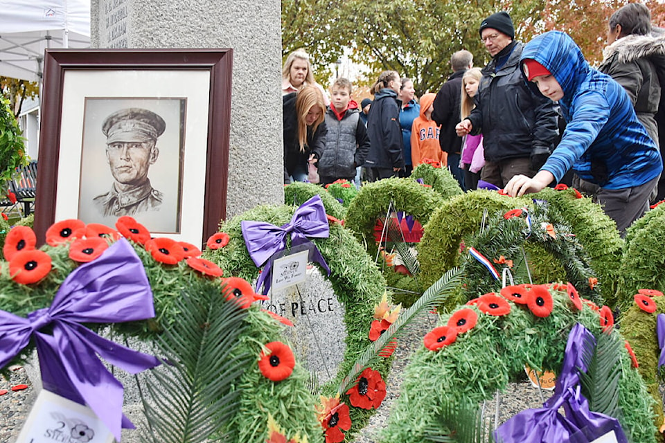 A portrait of Corp. Francis Pegahmagabow, who was the most highly decorated Indigenous Canadian from the First World War, sits on the cenotaph in Maple Ridge. The portrait was brought to the ceremony by Pegahmagabow’s proud grandson Terry. Hundreds turned out for the Remembrance Day ceremony at the cenotaph in Memorial Peace Park, downtown Maple Ridge on Friday, Nov. 11. (Colleen Flanagan/The News)