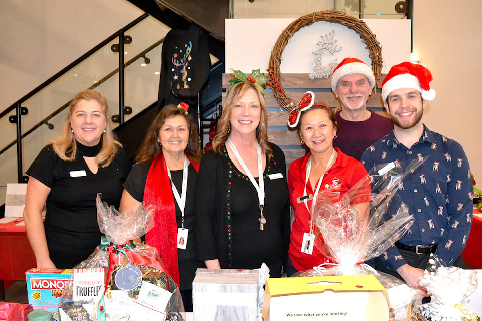 (L-R) executive director Vicki Kipps, community law advocate Charlotte Kingsbury, event organizer Heather Walker, Sue Fordyce, volunteer Larry Walker Sr., and Derian Domitruk helped oversee the 19th annual Community Christmas Silent Auction. (Brandon Tucker/The News)