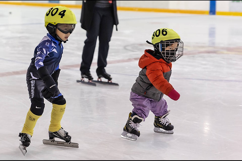 Ron He and Aila Bears just off the start line at the Jingle Bell Challenge speed skating meet. (Amber Gill/Special to The News)