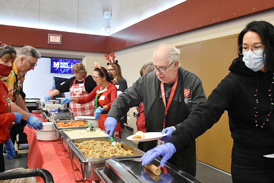 Chef Rob Field with the Salvation Army made it out of the kitchen at Maple Ridge Alliance Church, to serve food. (Colleen Flanagan/The News)