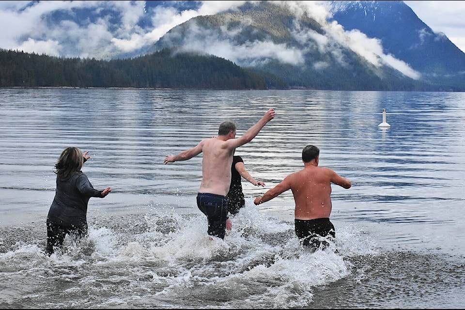 Laura Edwards, Glenda Pohl, Bernie Serne and Ken Klock take a polar bear plunge in Alouette Lake. (Neil Corbett/The News)