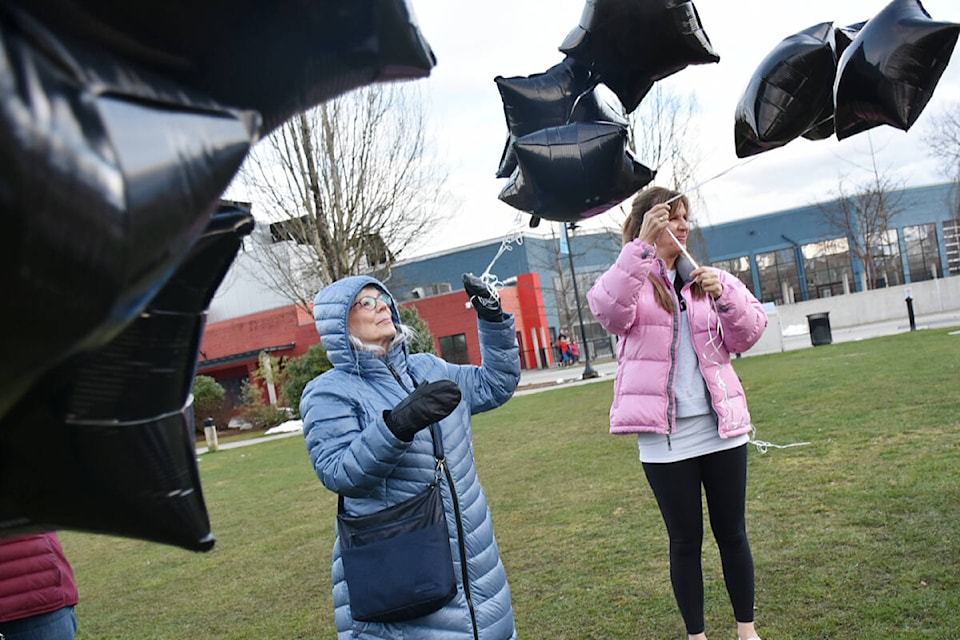 Participants hold black balloons in honour of the 36 people who died in Maple Ridge and Pitt Meadows last year due to illicit drug toxicity. (Colleen Flanagan/The News)