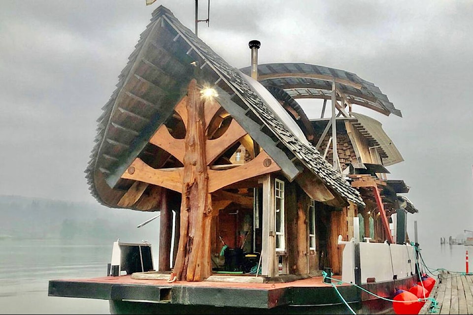 The floating home is a log house style construction on a former ferry hull. (Facebook Marketplace/Special to The News)