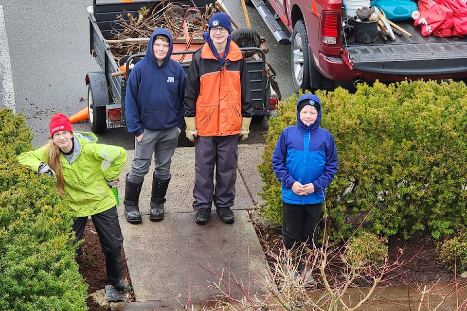 Joey Meunier, and fellow scouts, his younger brother Dylan, in addition to Emily Donaldson, and Liam Nelson, cleaned up the grounds at Ridge Meadows Hospital. His father, David Meunier, who is co-group commissioner with the 1st Haney Scout Group, and fellow scouter Margaret Cleaver, were on hand to supervise. (Special to The News)