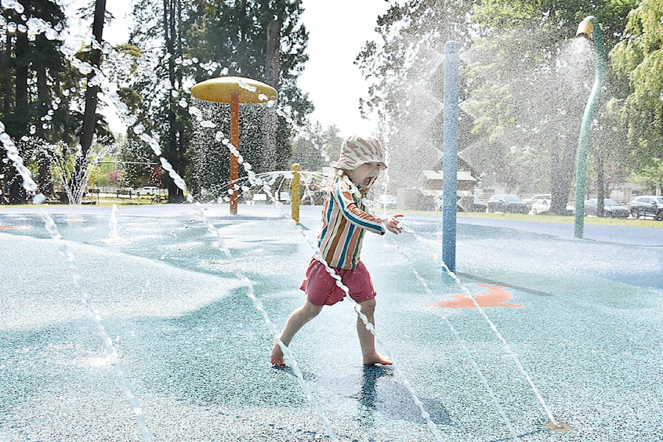 Louie, 2, runs through the spray park at Maple Ridge Park. (Colleen Flanagan/The News)