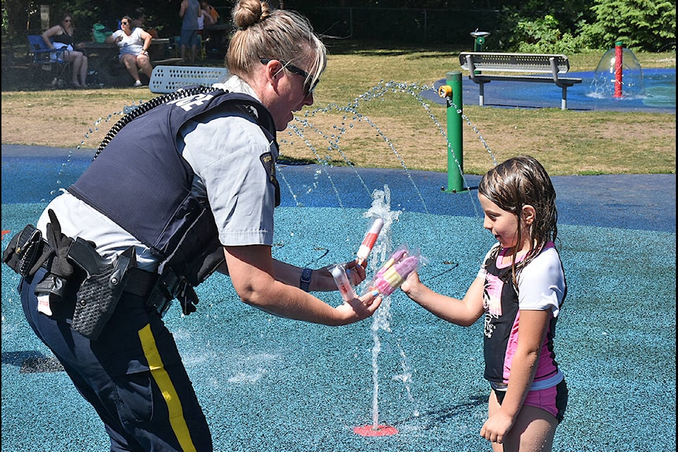 Cpl. Julie Klaussner hands out a popsicle. (Neil Corbett/The News)