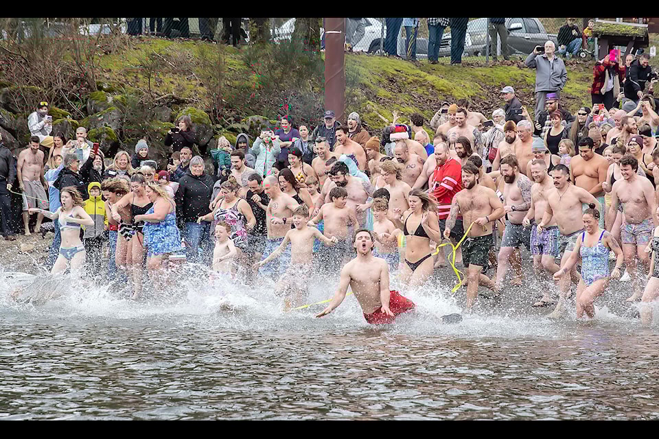 About 100 hardy souls braved the chilly six degree Celsius water temperatures at the annual polar bear swim at the Stave Lake Boat Launch on New Year’s Day. There were at least another 100 supporter watching the event and cheering on the brave swimmers.