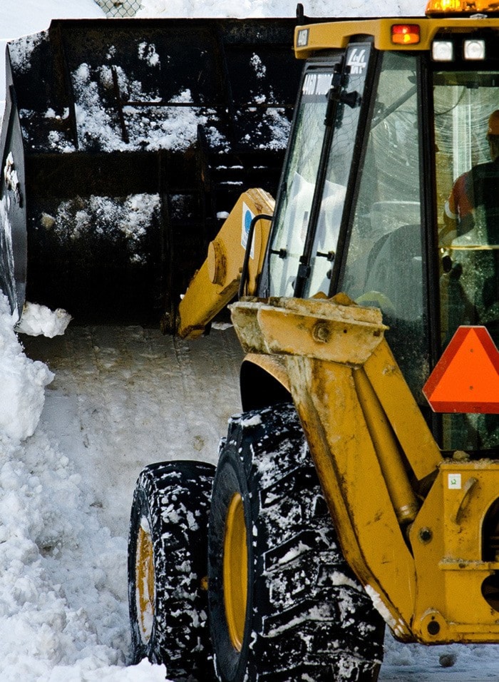 Person operating snow plow