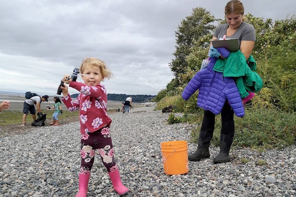 Leanna Wurz, 3, shows a plastic straw that she found on East Beach Thursday (Aug. 20) during a Great Canadian Shoreline Cleanup effort organized by her mom, Rachel. (Tracy Holmes photo)