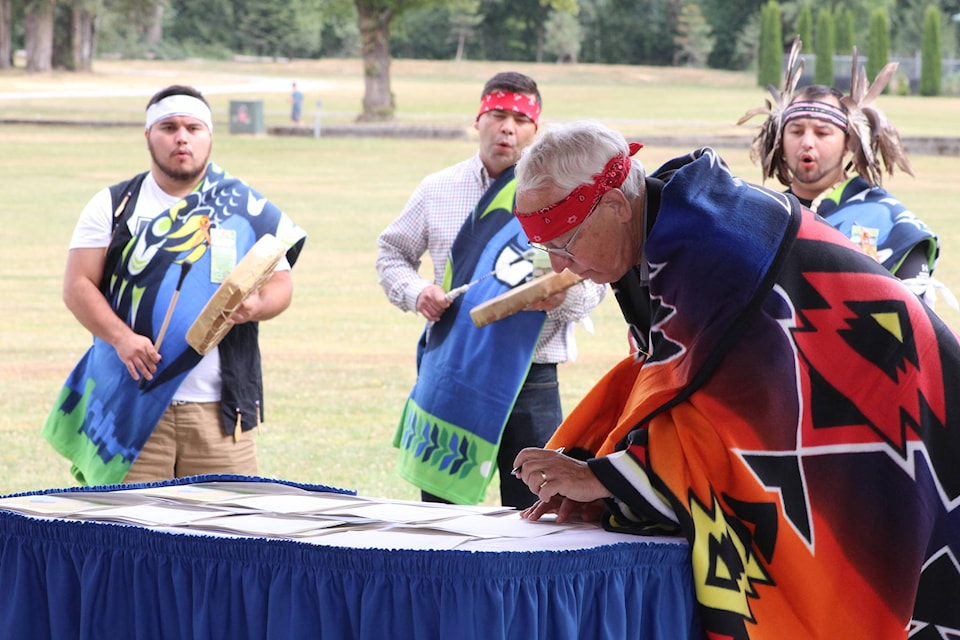 Minister of Indigenous Relations and Reconciliation Murray Rankin signing the agreement. Patrick Penner photo.