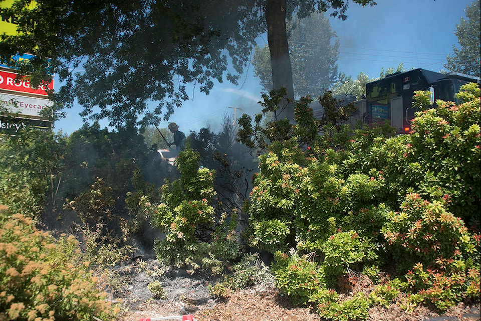 Smoke can be seen here rising form the brush before firefighters started to douse the flames. Johnston Zuma photo.