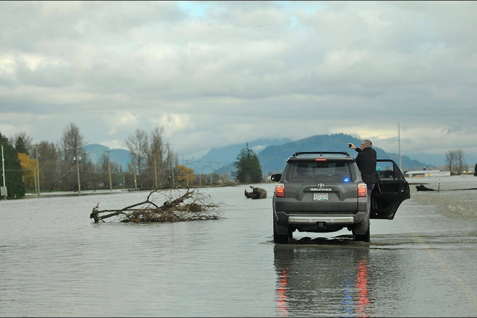 Abbotsford mayor Henry Braun captures video of a flooded section of Highway 1 between Cole Road and No. 3 Road looking east on Saturday, Nov. 20, 2021. (Jenna Hauck/ Chilliwack Progress)