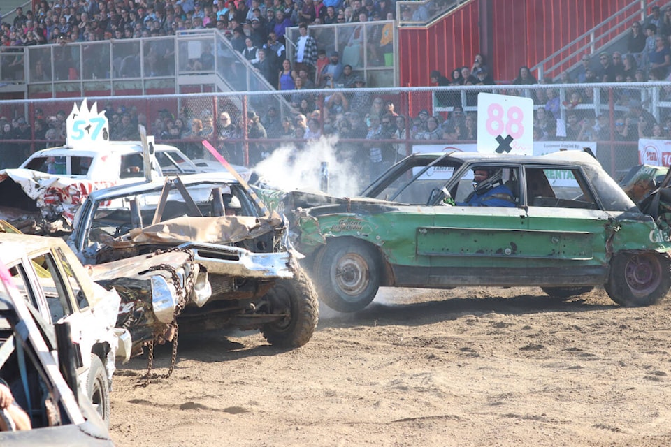 Armstrong Demolition Derby organizer - and driver - Lyle Williamson (Car 88) had an ongoing battle with Mission’s George Dover (left) in the opening heat Sunday, Oct. 9, at the IPE Grounds. (Roger Knox - Black Press)