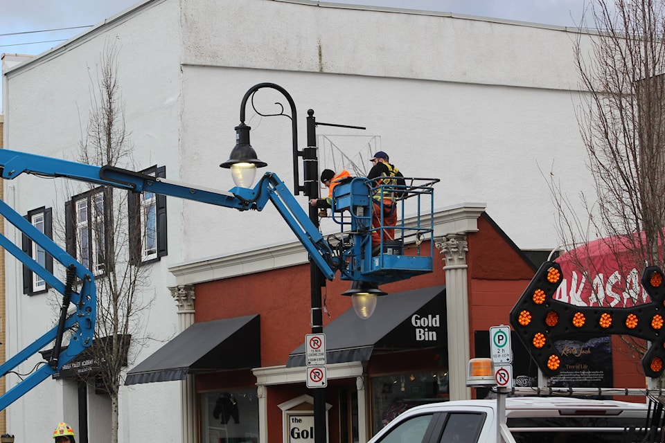 Crews raised light displays on First Avenue on Tuesday (Feb. 21) in preparation for the Shine Bright Mission event on March 3. /Dillon White Photo