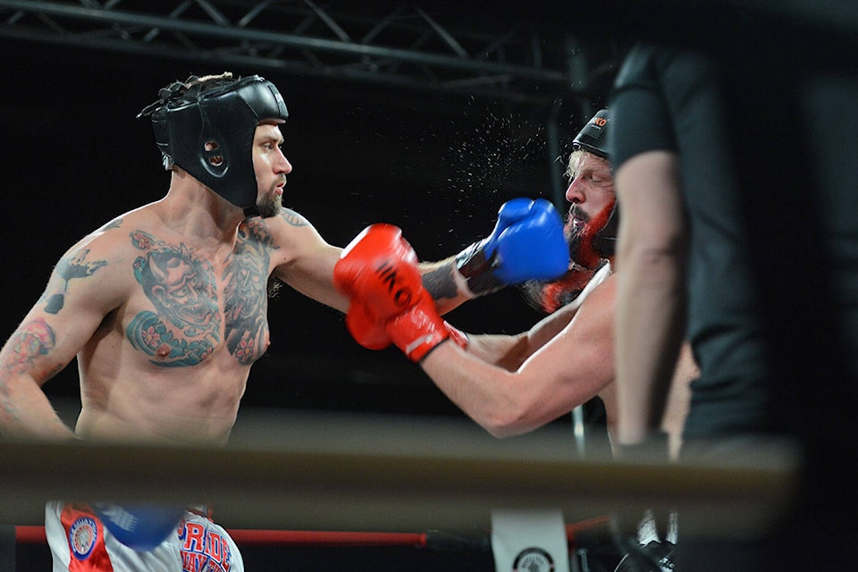 Erikson Deseron (red gloves) of Chilliwack’s Traditional MuayThai School and Tyrone Anderson (blue gloves) of Pride Muaythai (Richmond) fight during Muaythai Gladiators 2 at the Landing Sports Centre in Chilliwack on Saturday, Feb. 25, 2023. (Jenna Hauck/ Chilliwack Progress)