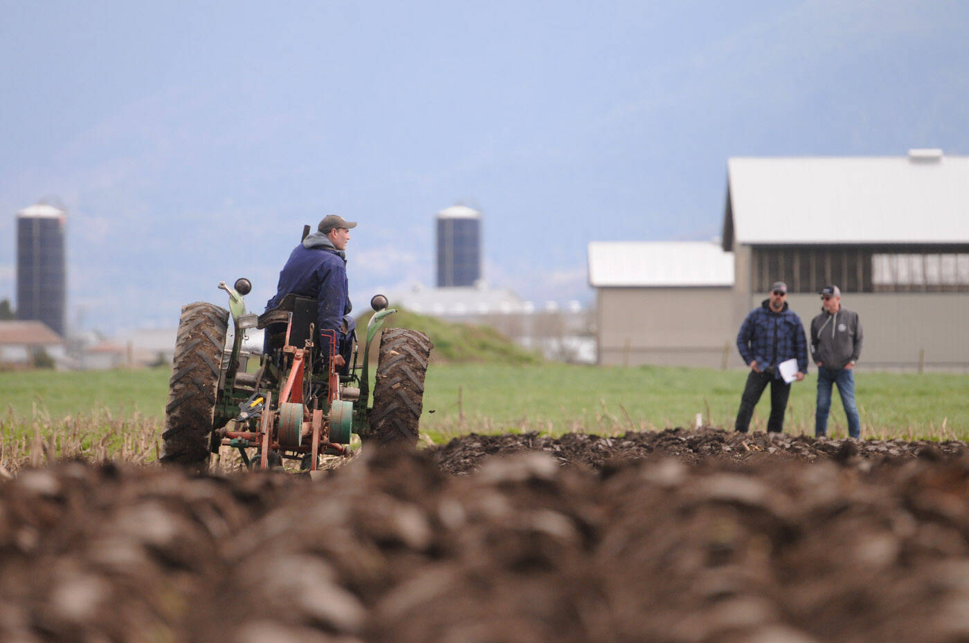 Pierre Sache of Rosedale competes in the 100th annual Chilliwack Plowing Match while judges look at his plot at Greendale Acres in Chilliwack on Saturday, April 2, 2022. (Jenna Hauck/ Chilliwack Progress file)