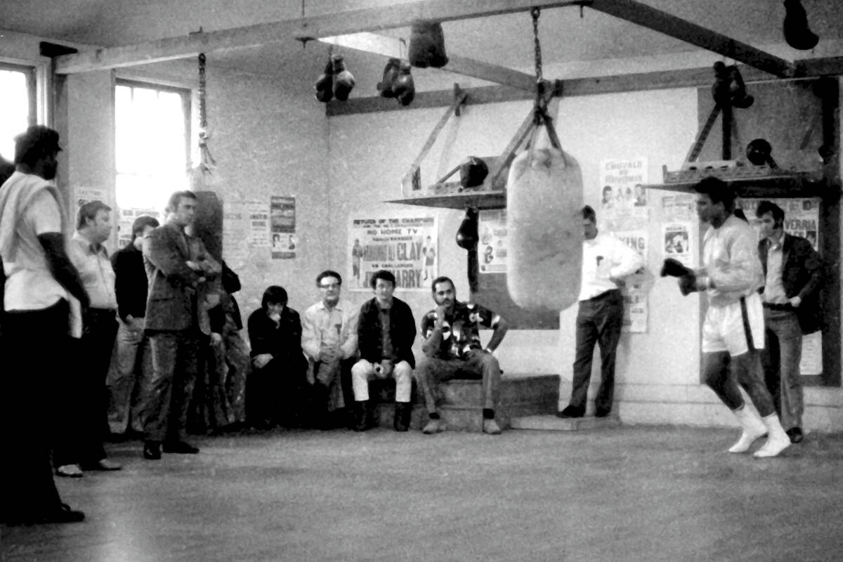 Muhammad Ali works on the bag while a small gathering of fans watch in April 1972. Photo courtesy John Ius