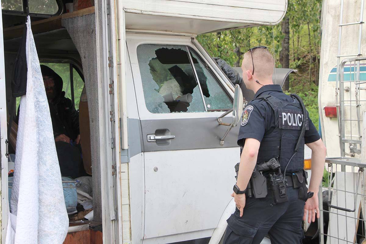 Const. Zach Parker talks to a man occupying an RV at the Lonzo Road homeless camp on May 4. (Vikki Hopes/Abbotsford News)