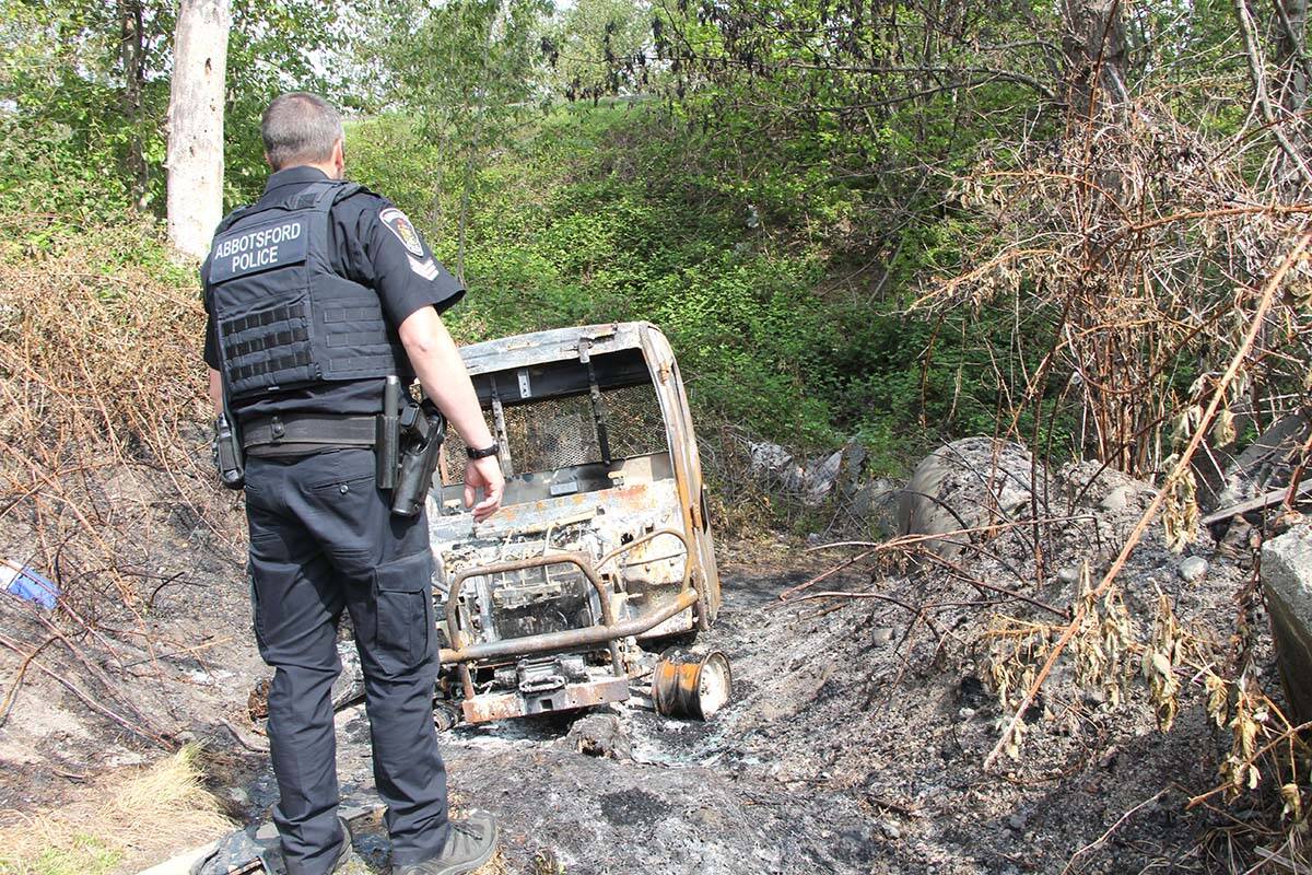 Sgt. Paul Walker checks out a burned-out rugged terrain vehicle at the Riverside camp. The RTV, worth $30,000, was soon confirmed to have been stolen from a nearby equipment dealer. (Vikki Hopes/Abbotsford News)