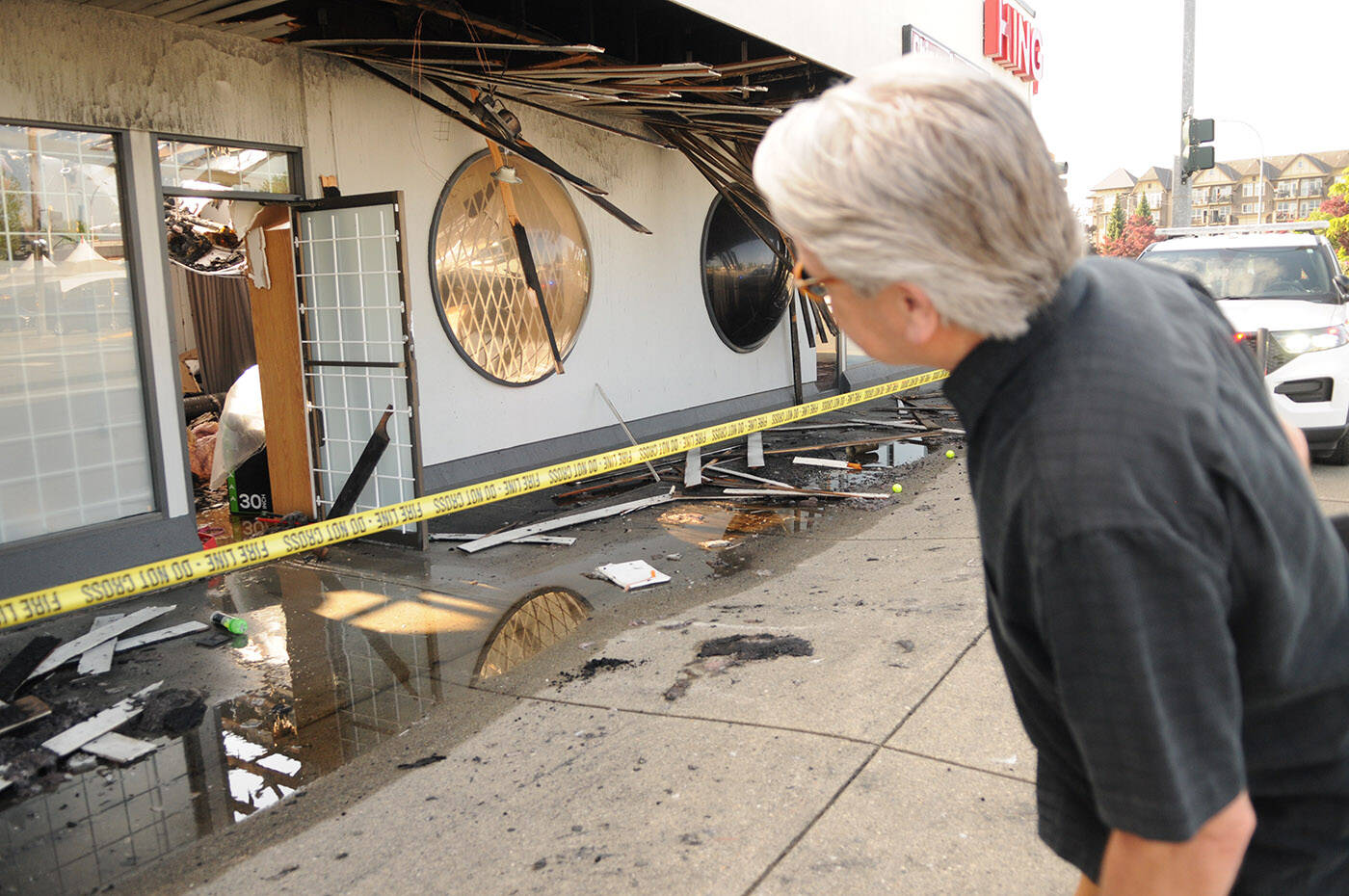 Mayor Ken Popove gets a closer look after an early-morning fire destroyed two businesses on Young Road in Chilliwack on Tuesday, May 16, 2023. There was damage to at least one other business in the same commercial building. (Jenna Hauck/ Chilliwack Progress)
