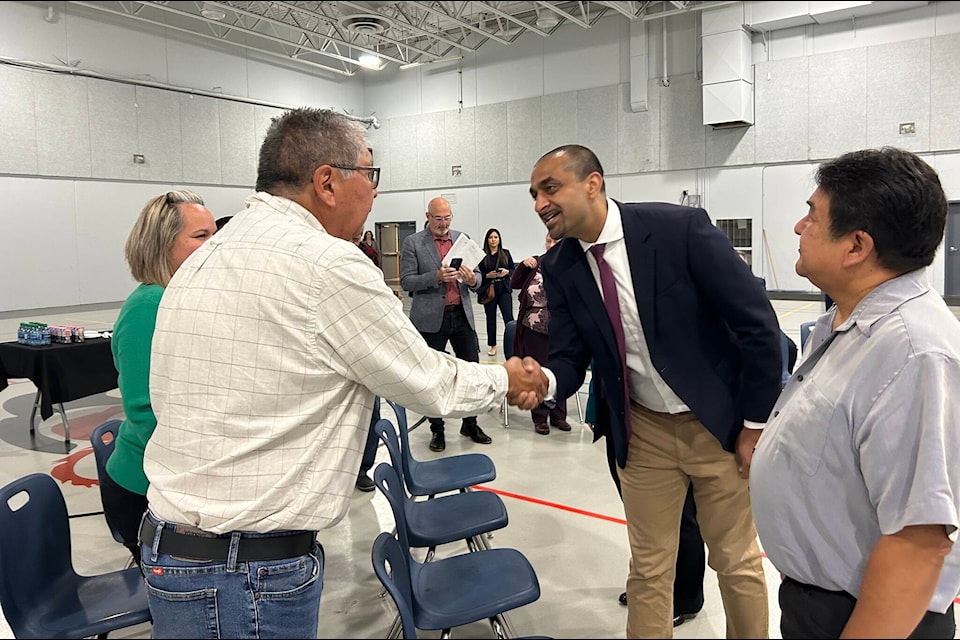 B.C. housing minister Ravi Kahlon (centre) shakes hands with Coun. Rodney Peters. Kahlon, with Chief Jim Harris (right) announced a 34-unit housing project for the Seabird Island community. (Adam Louis/Observer)