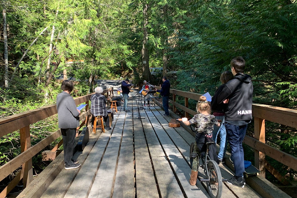 Neighbours gathered to enjoy a musical tribute on the bridge leading to a home on Brookview Drive in Metchosin. The band played John Prine songs in memory of the singer-songwriter who died on April 7. Less than one year ago, their bridge was host to a memorial for their neighbour, Martin Payne, who was found dead in his home in July. (Shalu Mehta/News Staff)