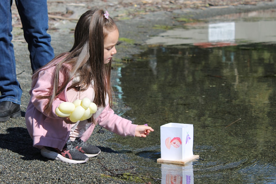 Mila Hong sets a handmade lantern into Sway’ A’ Lana Lagoon. Creating lanterns to float on the lagoon and hang in trees will be some of the activities at Nanaimo’s first Mid-Autumn Festival on Saturday, Sept. 14, at Maffeo Sutton Park.