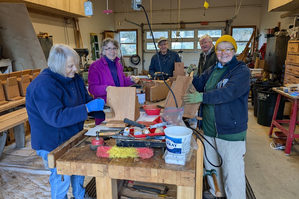 Sally Hodmeier, Julie Deveraux, Josef Bauer, Helmut Demoulin, and Helena Kreowska from Nature Nanaimo build replacement nest boxes for the Western purple martin.