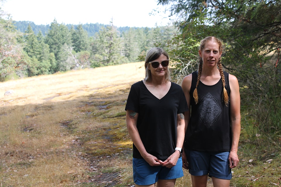 Jackie Wasyluk and Jain Alcock-White of Save Cable Bay stand by a Garry oak meadow inside the 80.9 hectares of land the group wants to purchase.