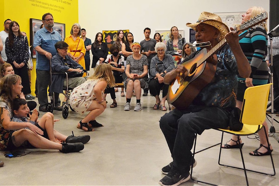 Willie Thrasher and Linda Saddleback sing and play for the crowd during Nanaimo Art Gallery’s opening reception on Friday, July 12, for the Double Vision exhibit, which will show at the gallery until Sept. 15. 