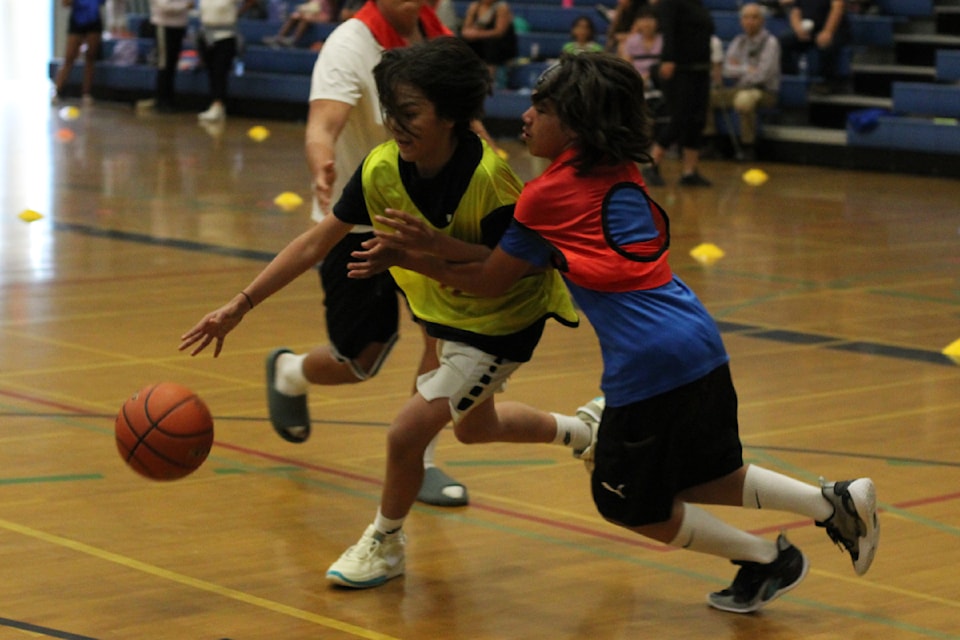 Pheonix Sampson from Snaw-Naw-As battles with Kenny Lucas from Snuneymuxw for control of the ball in the Coast Salish Games basketball final on Wednesday, July 24, at John Barsby Secondary School.
