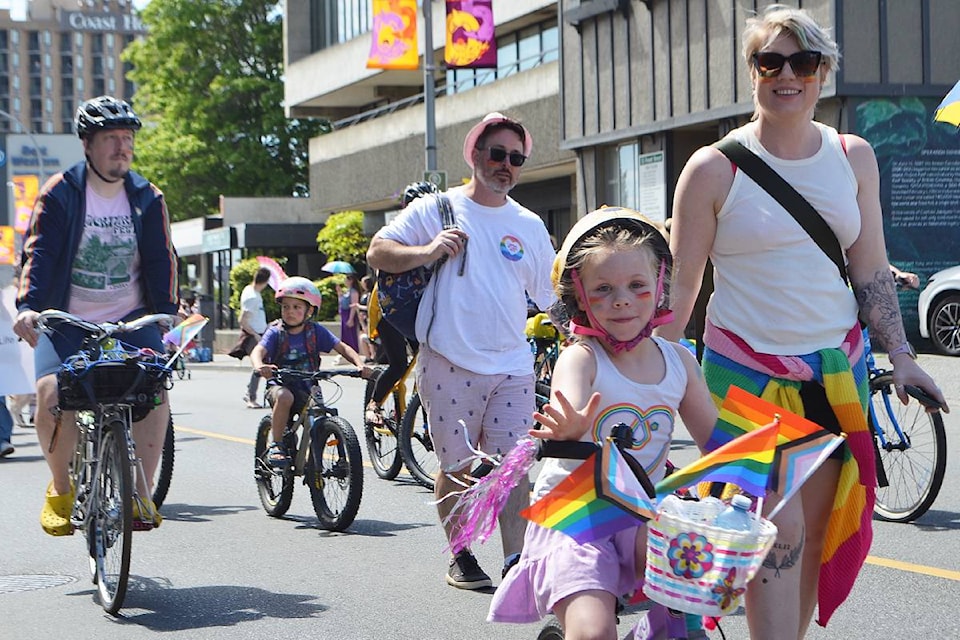 Community members ride their bikes and march through downtown Nanaimo toward Maffeo Sutton Park on Sunday, June 9, during the Pride parade, as organized by the Nanaimo Pride Society. 