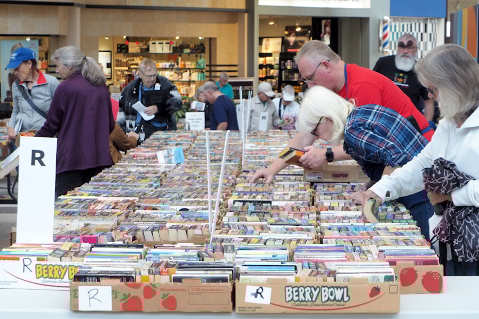 Avid readers avail themselves of the selection of 100,000 books set out for sale on opening day of the Rotary Used Book Sale at Nanaimo North Town Centre.