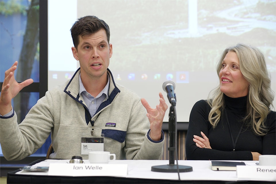 Renee Olson, interim CEO of Khowutzun Development Corp. listens to Ian Welle, CEO of Polar Engineering, describe a Danish experiment in energy storage.