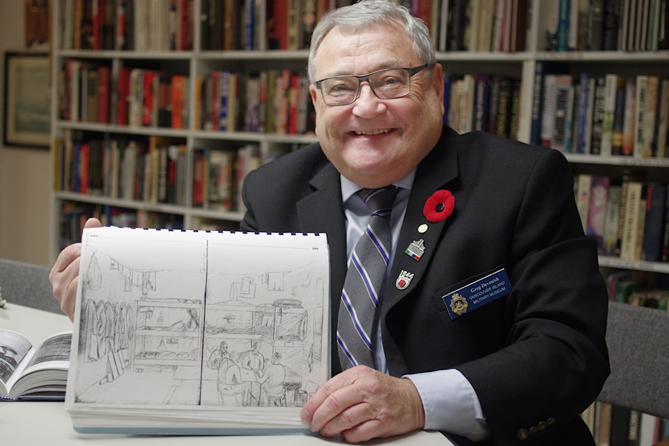 Greg Devenish, VIMM board member and the museum's librarian holds an illustration drawn by John Colwell in his diary stashed away with a compilation about Colwell's life by former museum member Harold Johnstone. 