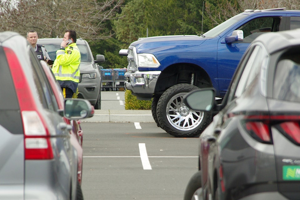 Police in Nanaimo stand by a vehicle involved in a fatal collision in the Walmart parking lot last March. 
(News Bulletin file photo)