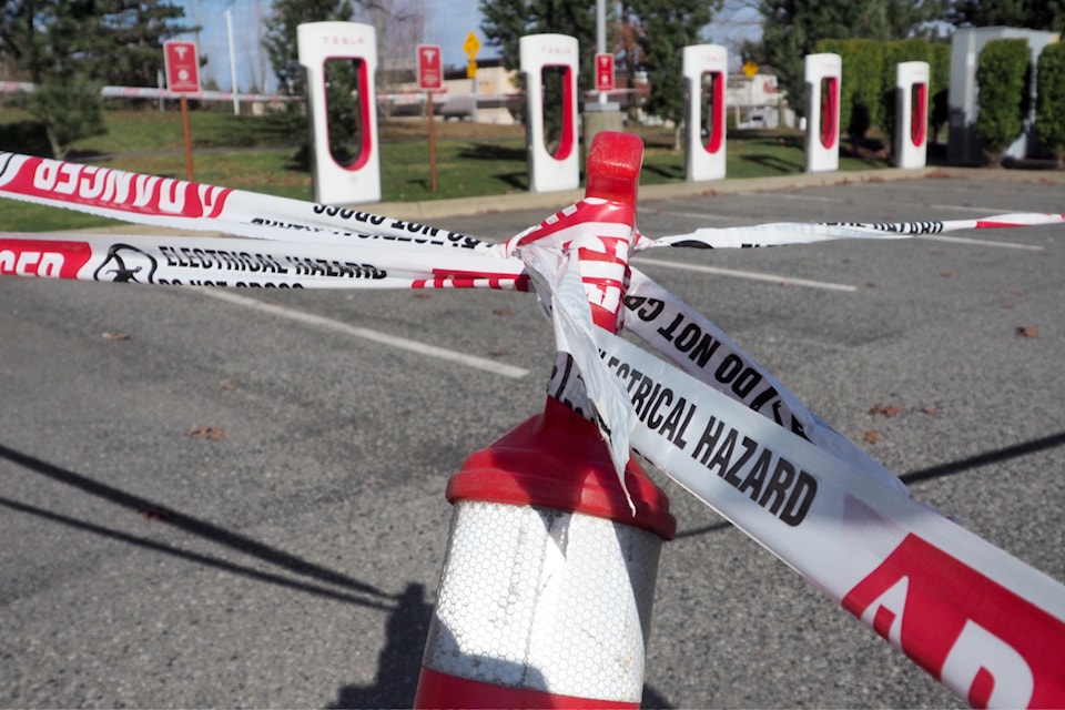 All eight stalls of a Tesla supercharger station are behind caution tape after two were destroyed by fire and others appeared to have been tampered with in Nanaimo on the weekend. 
(Chris Bush/News Bulletin)