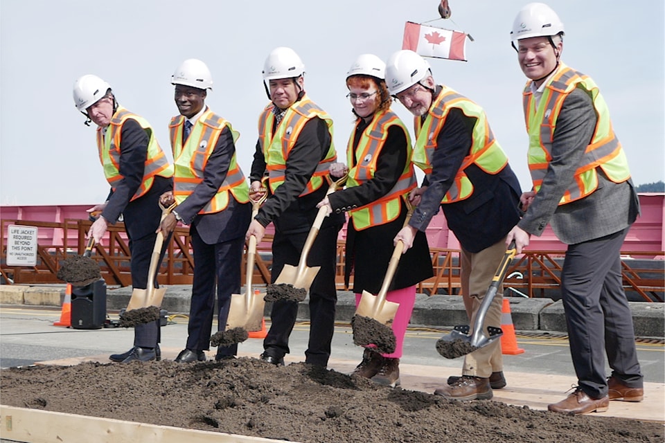 Ian Marr, Port of Nanaimo president and CEO, left, George Anderson, parliamentary secretary for transit; Chief Mike Wyse, Snuneymuxw First Nation; Donna Hais, Port of Nanaimo chair; Nanaimo mayor Leonard Krog and Joel Werner, chief operating officer for DP World Canada, toss some sod in a groundbreaking ceremony to kick off the Duke Point terminal expansion.
(Chris Bush/ News Bulletin)