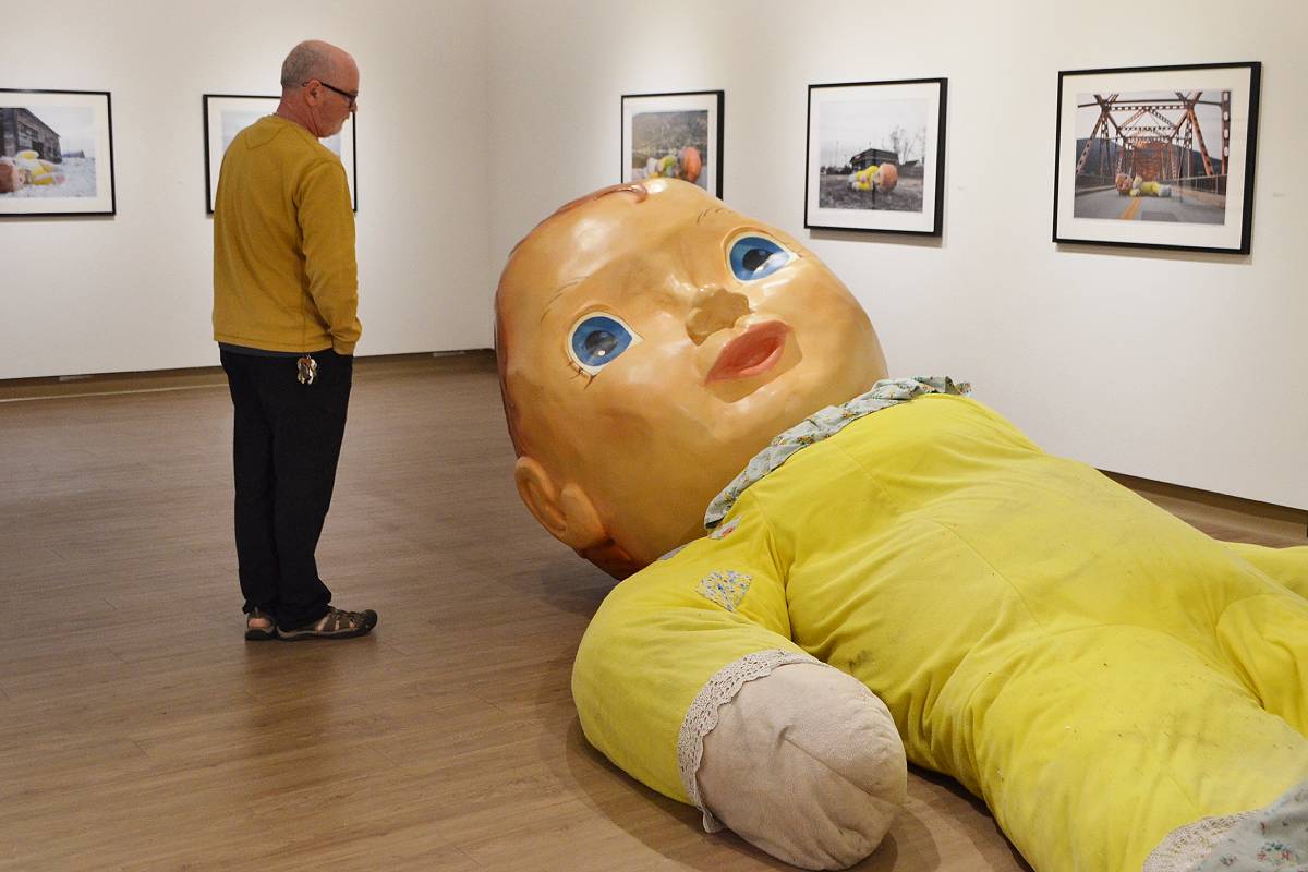 Island artist explores home and loss with giant doll and burning dollhouse