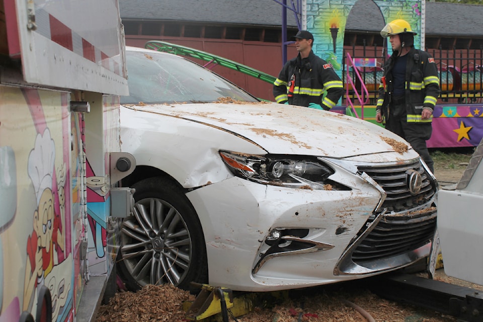 A driver crashed a luxury vehicle through two walls of a barn at the Beban Park fairground on Wednesday, Sept. 18, while the Vancouver Island Exhibition was being set up. (Jessica R. Durling/News Bulletin)