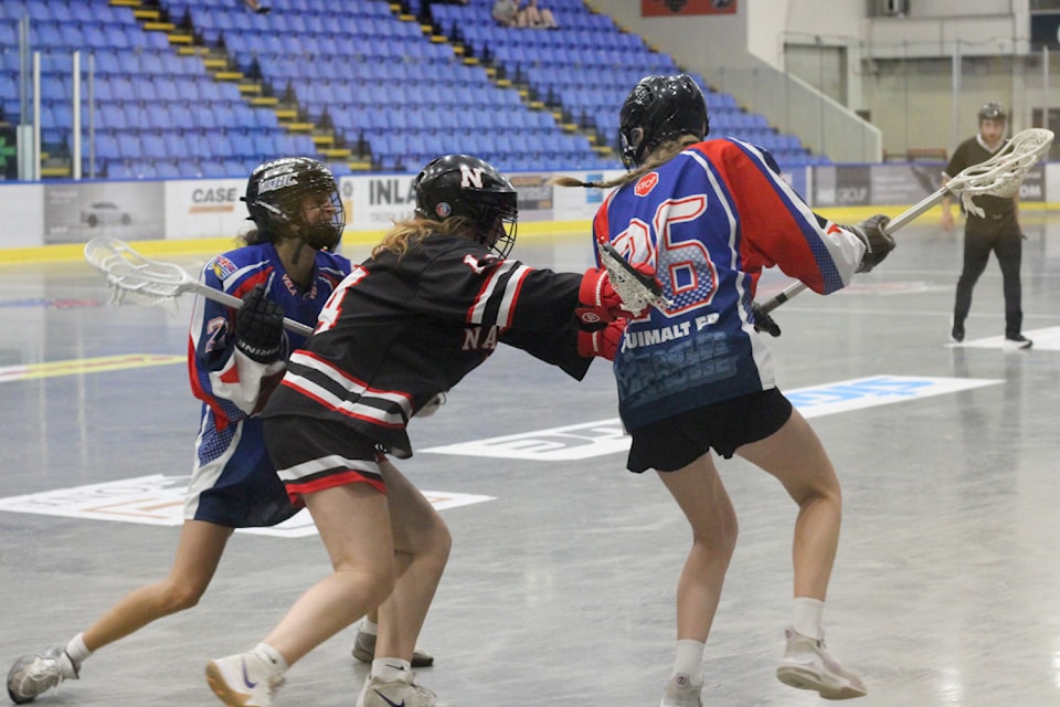 Nanaimo Timbermen player Elise Olson checks Victoria-Esquimalt Eagles opponent Hayley Alexander during U22 action Thursday, July 10, at Frank Crane Arena. (Greg Sakaki/News Bulletin)