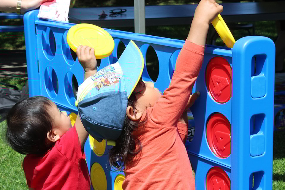 Cassie Manzano, left, and Luca Kemp play Connect 4 at Maffeo Sutton Park on Canada Day.