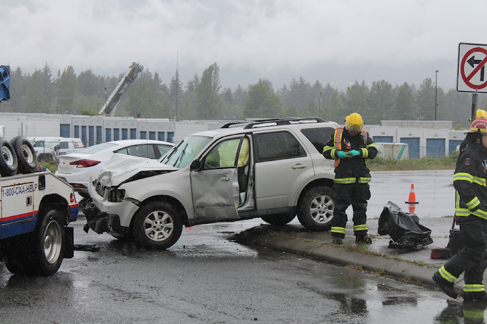 A crash on the old Island Highway in front of Country Club Centre on Thursday, May 15, resulted in one person being transported to hospital. (Jessica R. Durling/News Bulletin)