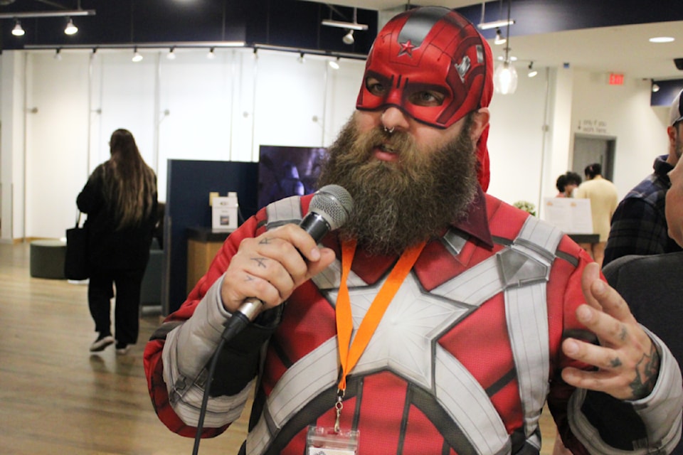 Matthew Schmidt, or Red Guardian of Thunderbolts fame, warns people that the silent auction is about to close at Curious Comicon on Saturday, May 3. (Karl Yu/News Bulletin)